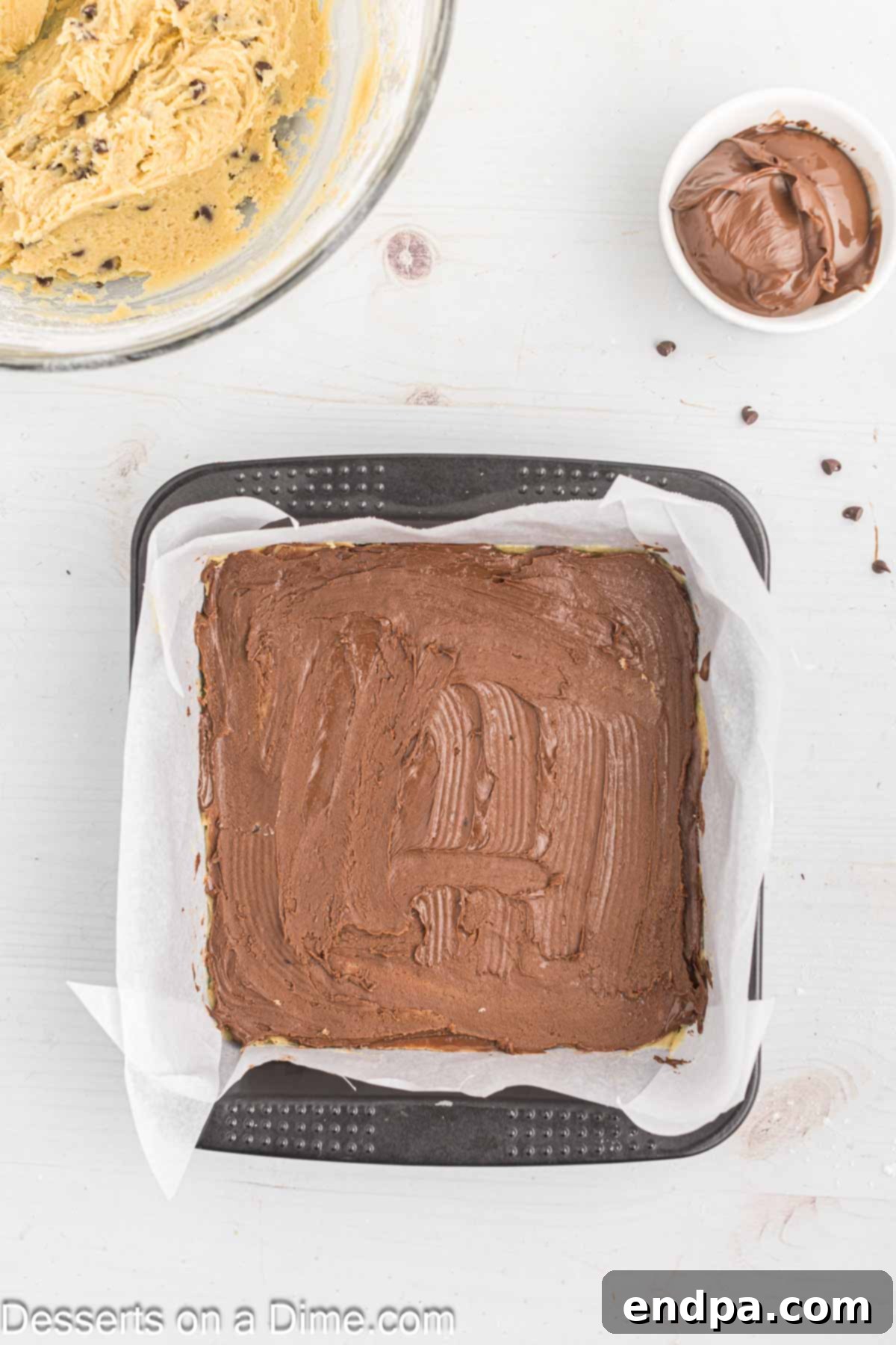 Decadent Nutella Bars 9 Half of the Nutella spread in an even layer over the cookie dough base.