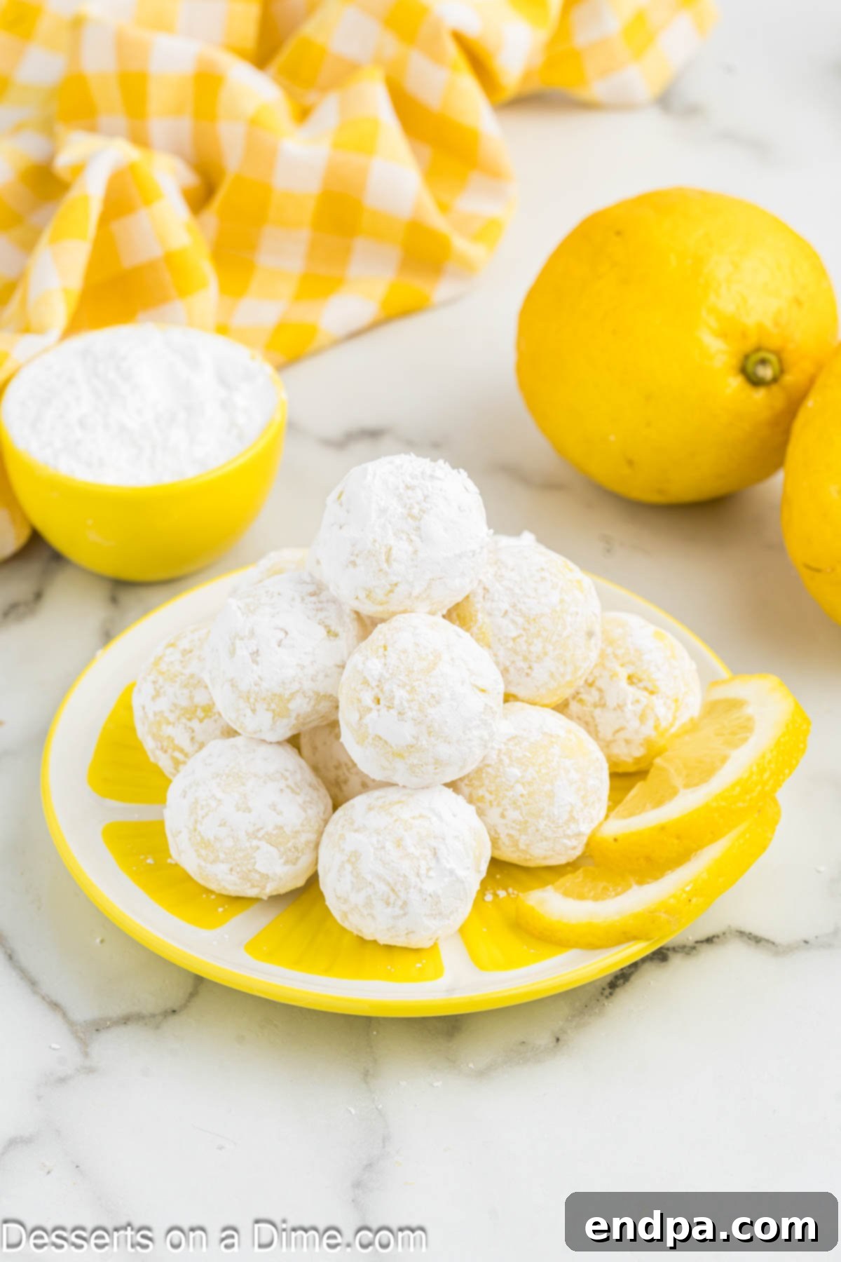 Lemon Truffles on a plate, garnished with fresh lemon slices.