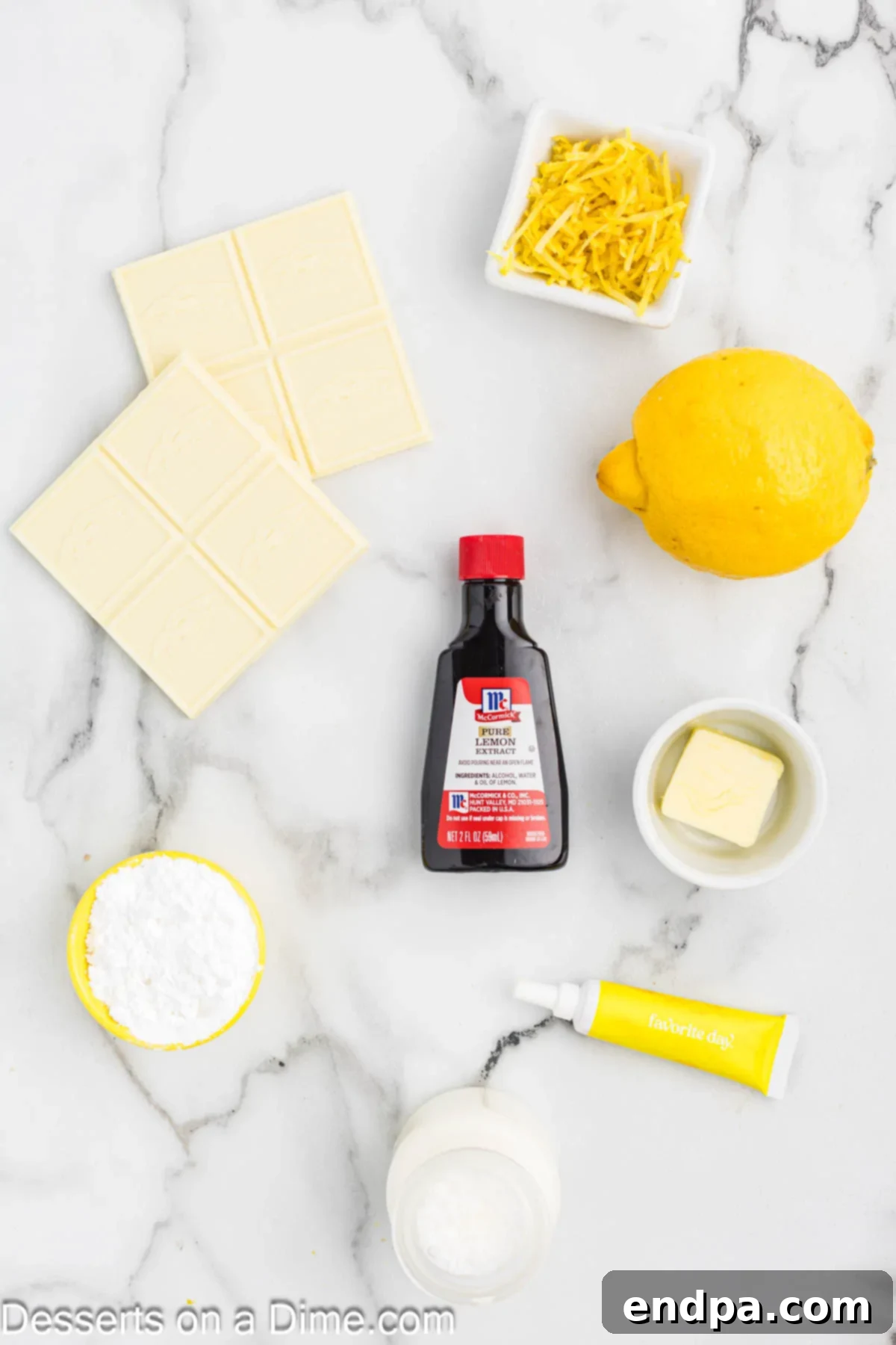 Ingredients for the Lemon Truffle recipe: white chocolate baking bars, heavy cream, lemon zest, butter, yellow food coloring, and lemon extract.