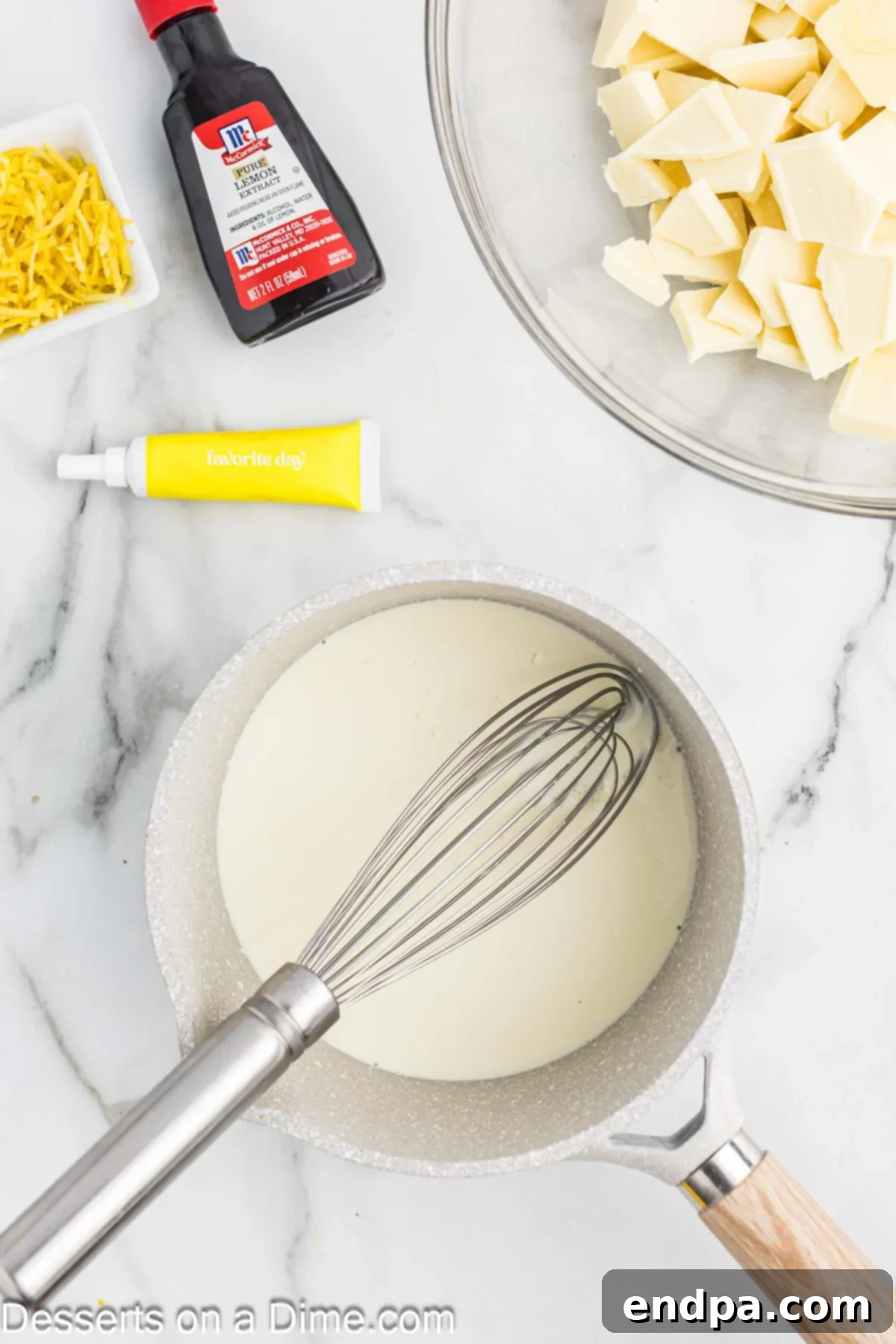 Heavy whipping cream heating in a small saucepan.