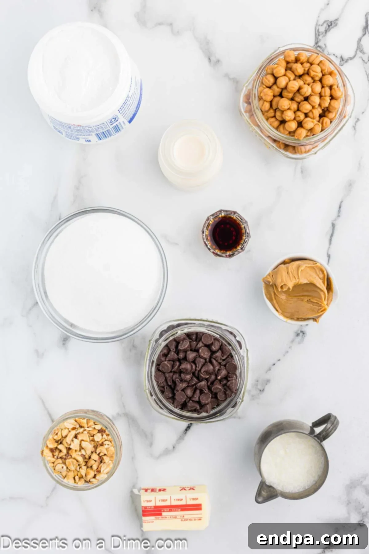 Ingredients for recipe - chocolate chips, peanut butter, butter, evaporated milk, milk, vanilla, peanuts, caramels, heavy whipping cream.