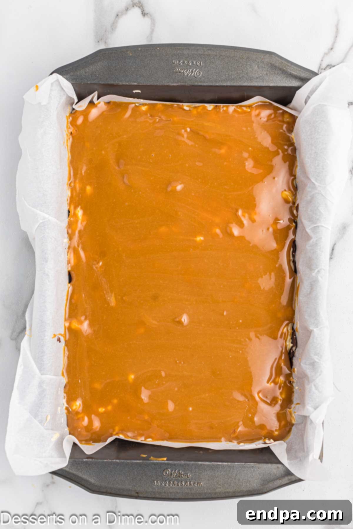 Caramel mixture spread in pan.