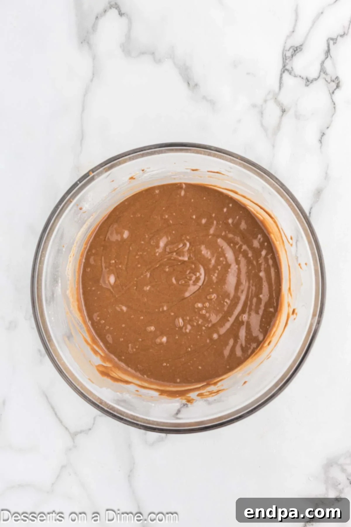 Mixing bowl with smooth chocolate mayonnaise cake batter.