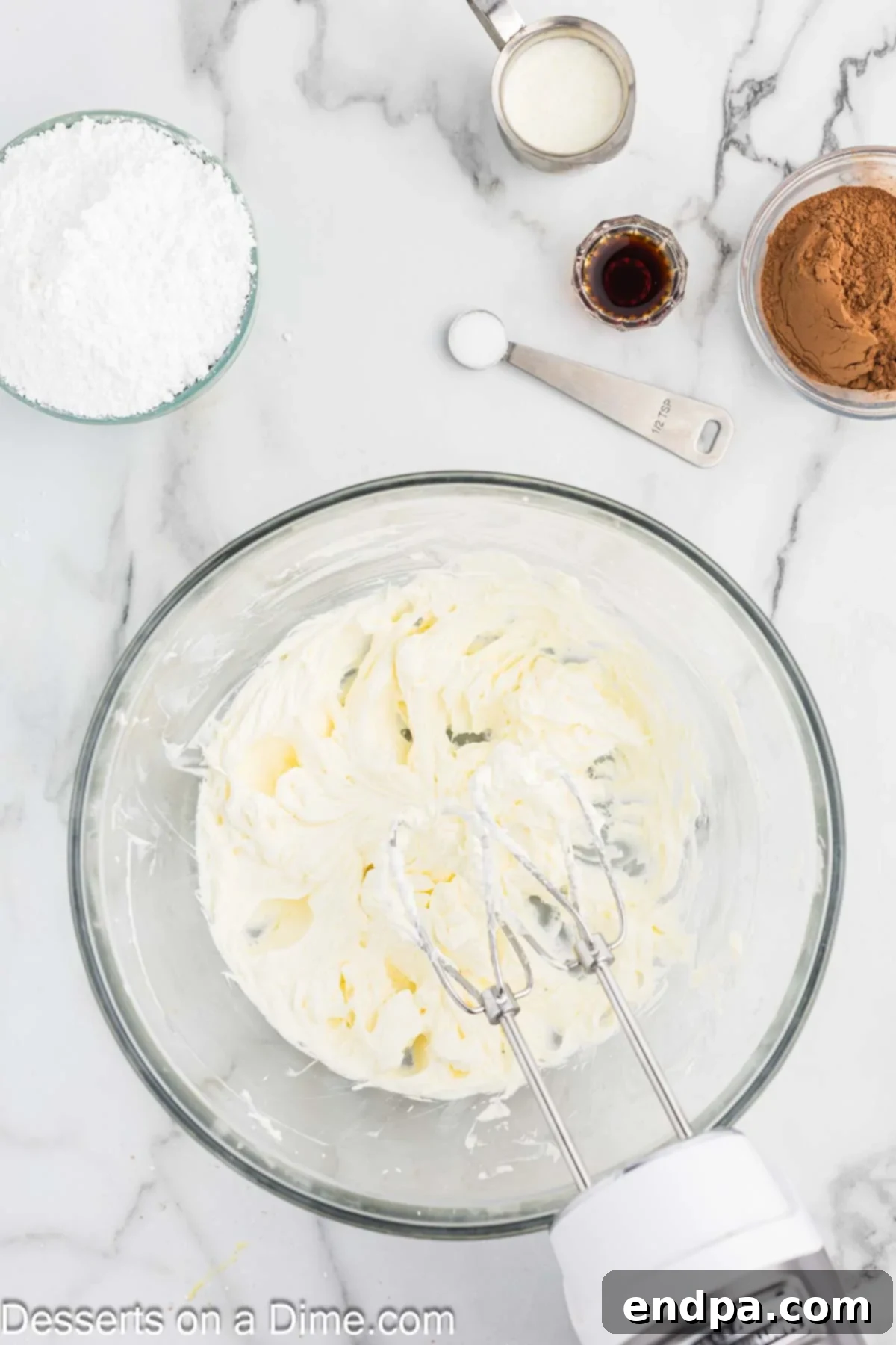 Cream cheese and butter combined in a mixing bowl for frosting.