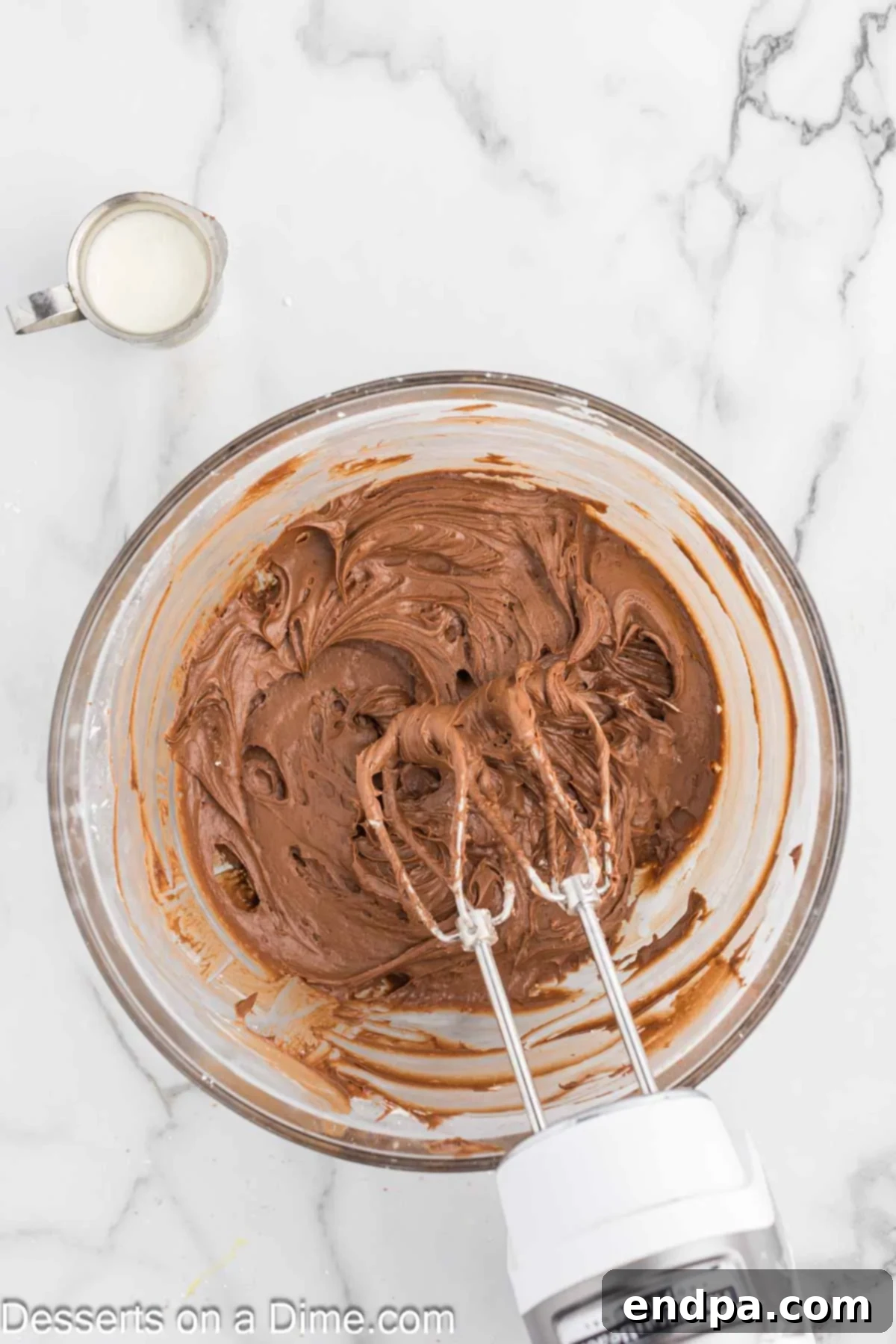 Powdered sugar, cocoa powder, heavy cream, vanilla extract, and salt added to the cream cheese and butter mixture for frosting.