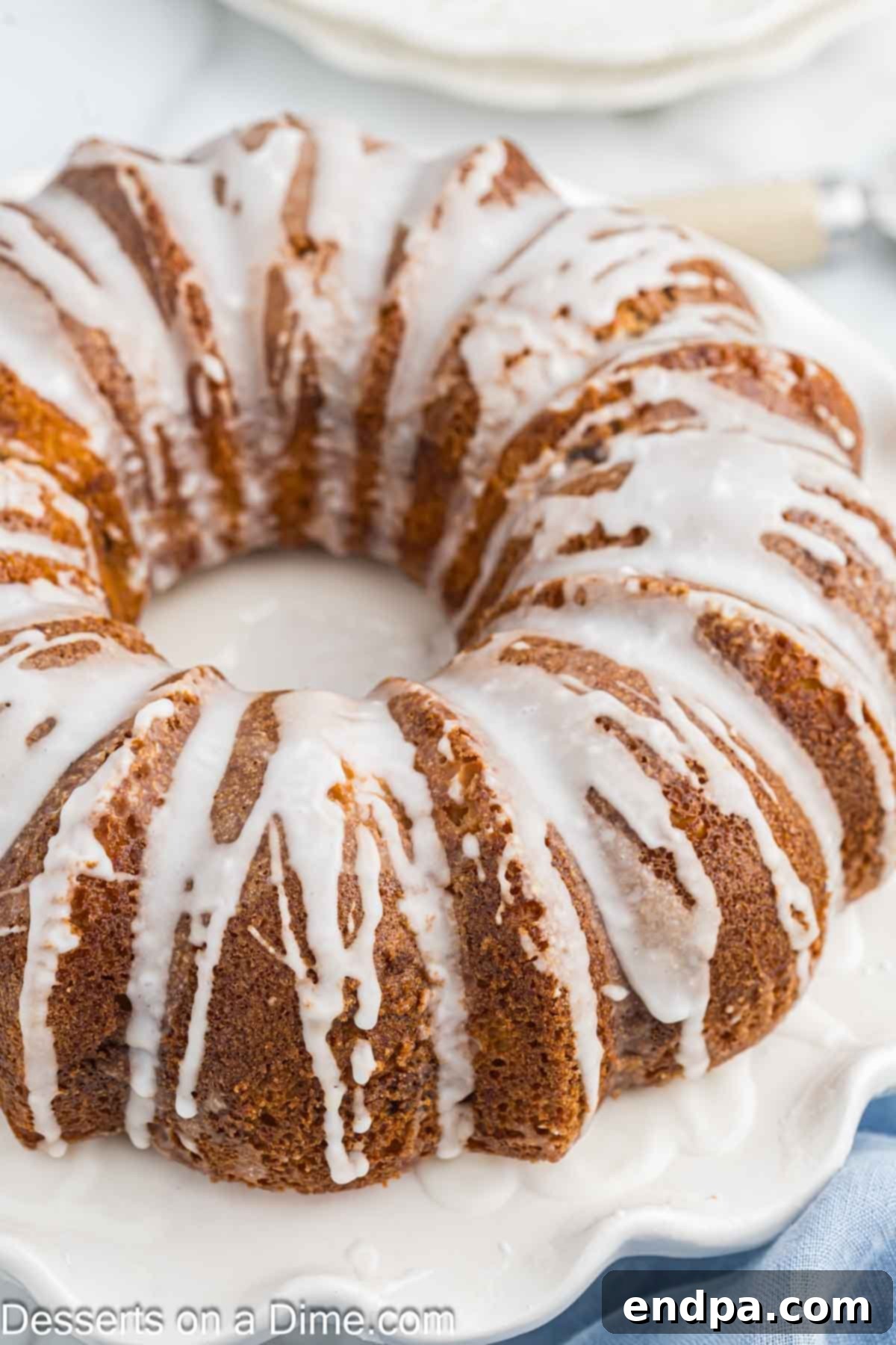 Sock it to Me Bundt Cake on a platter with glaze. A beautifully baked cake with a sweet drizzle.