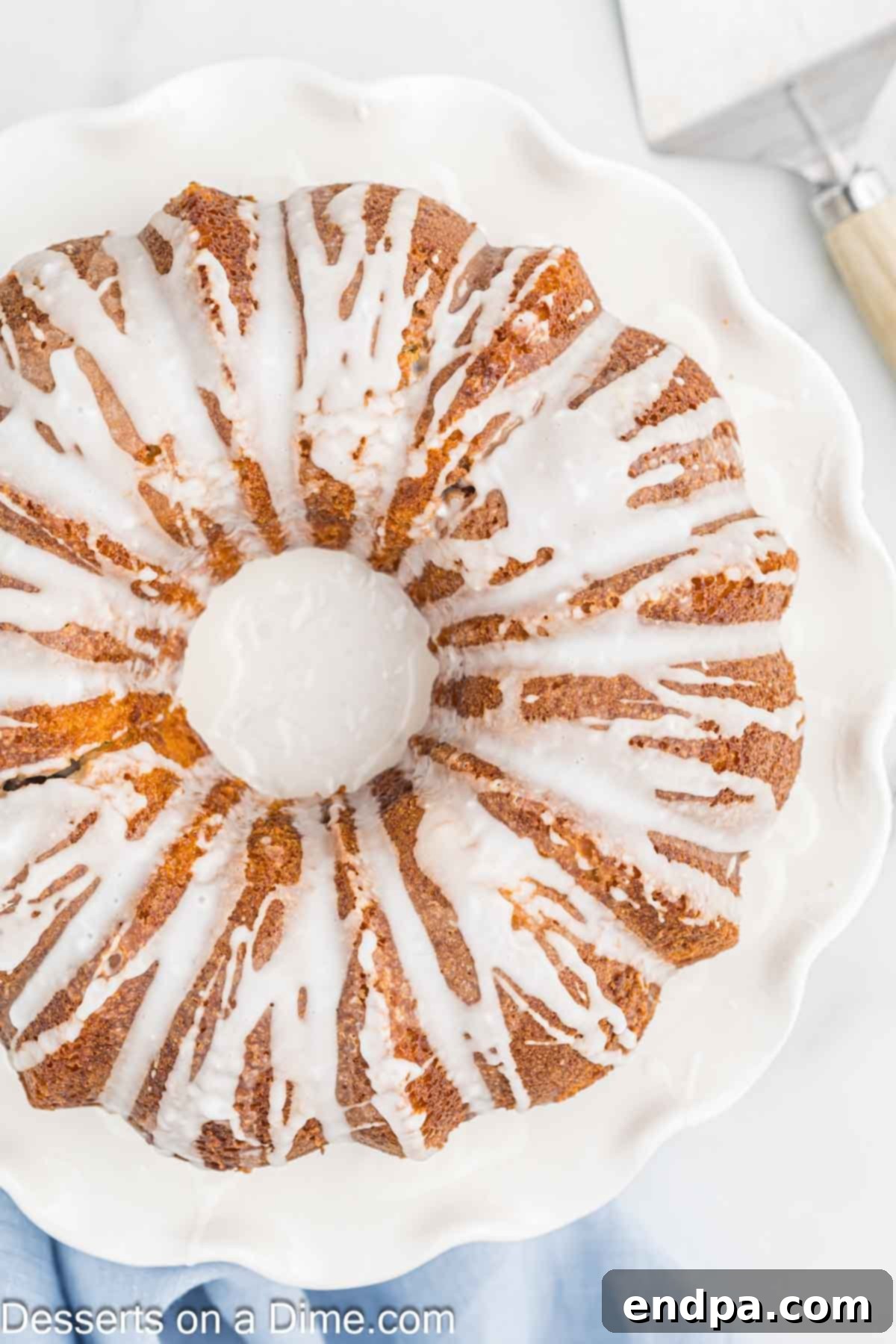 Cake topped with glaze. The Sock It To Me Bundt Cake beautifully drizzled with its sweet, white glaze.