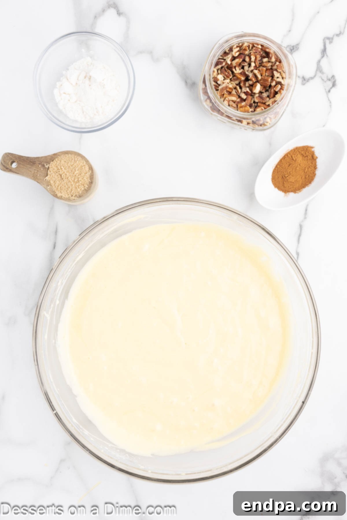 Mixing bowl with cake batter combined. A creamy, smooth yellow batter ready for baking.