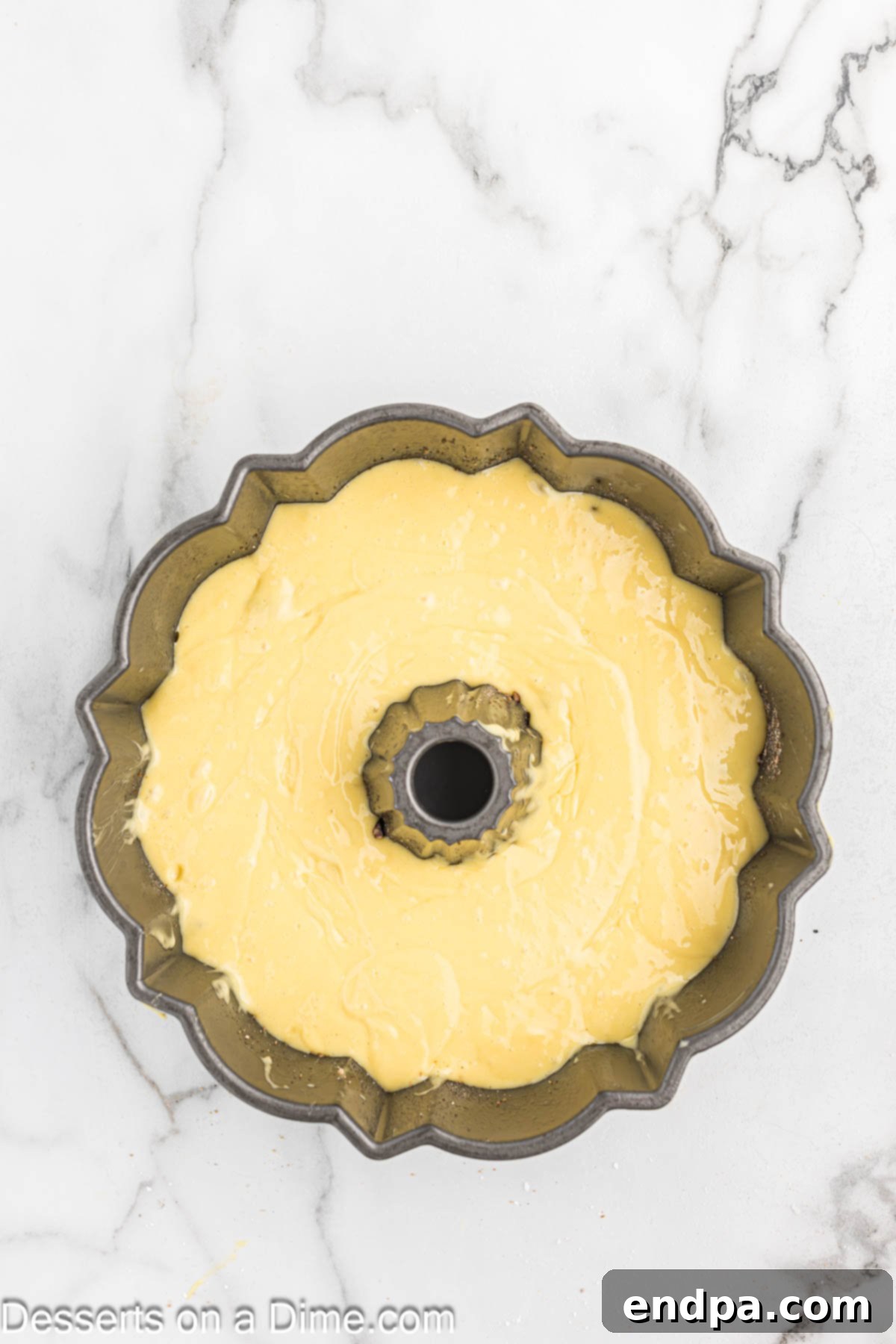 Another layer of batter in pan. The remaining cake batter covering the streusel layer.