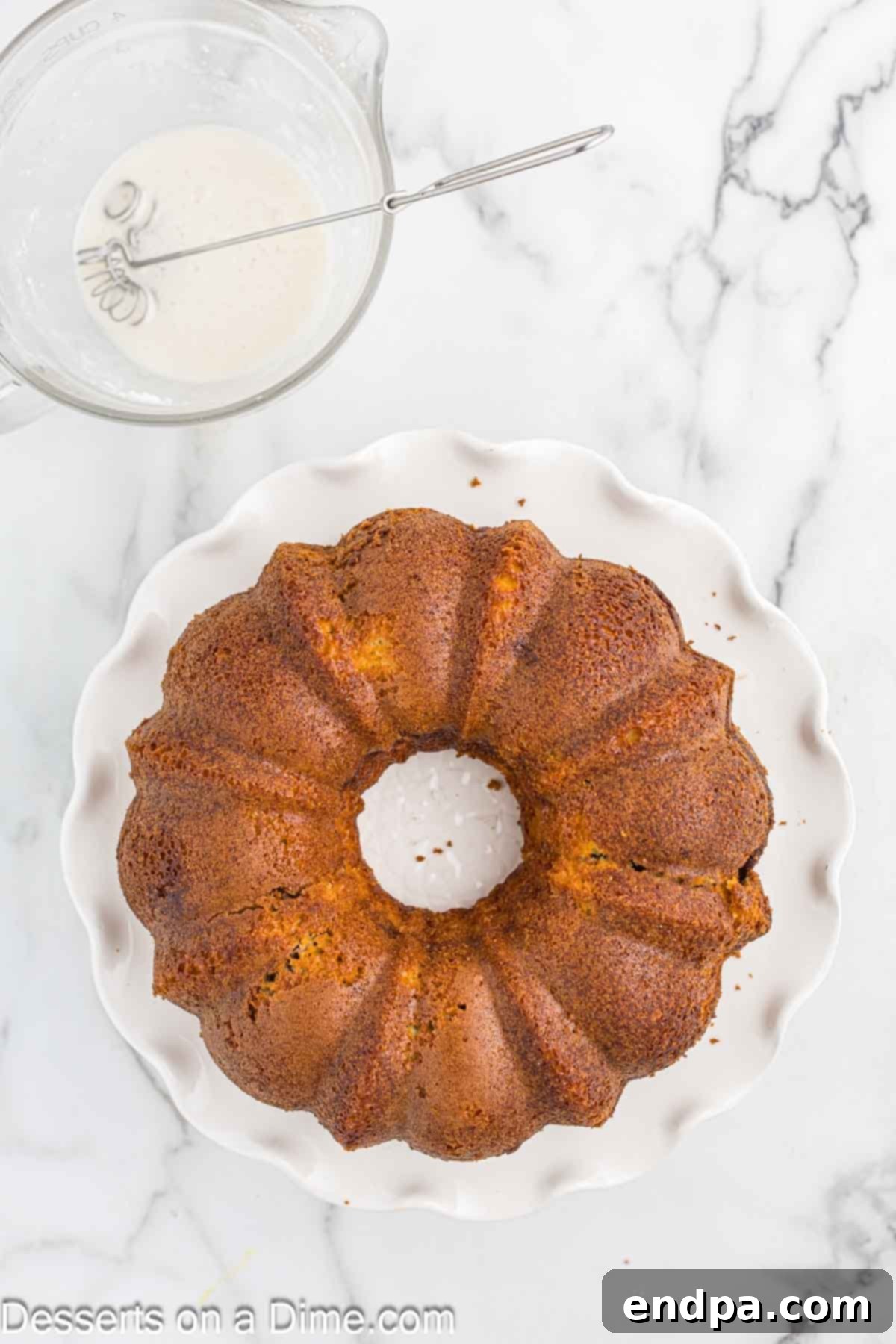 Cake on platter cooling. The bundt cake has been inverted onto a serving platter and is cooling completely.
