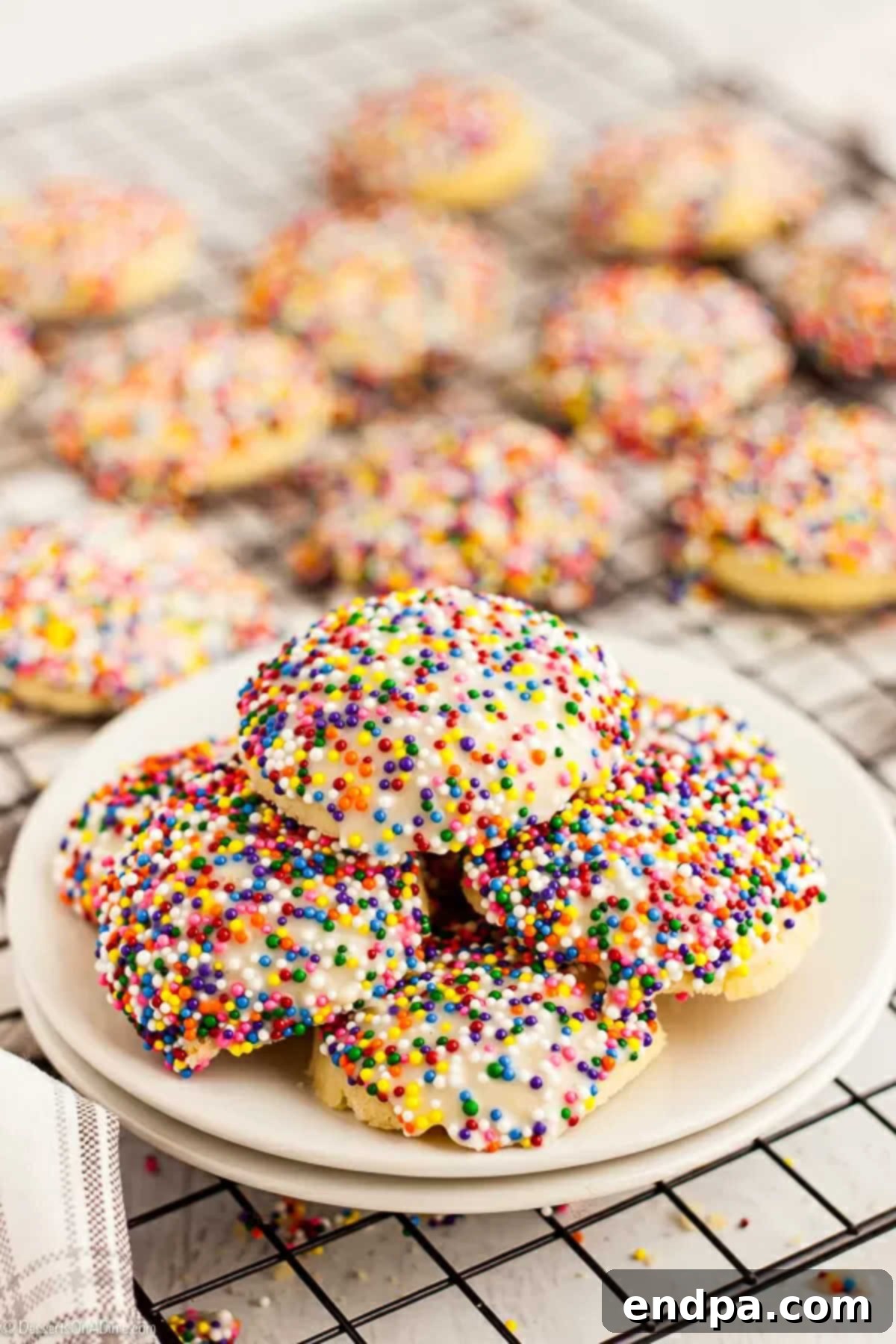 A festive platter of homemade Italian cookies, beautifully glazed and decorated with colorful sprinkles, ready to be served and enjoyed.