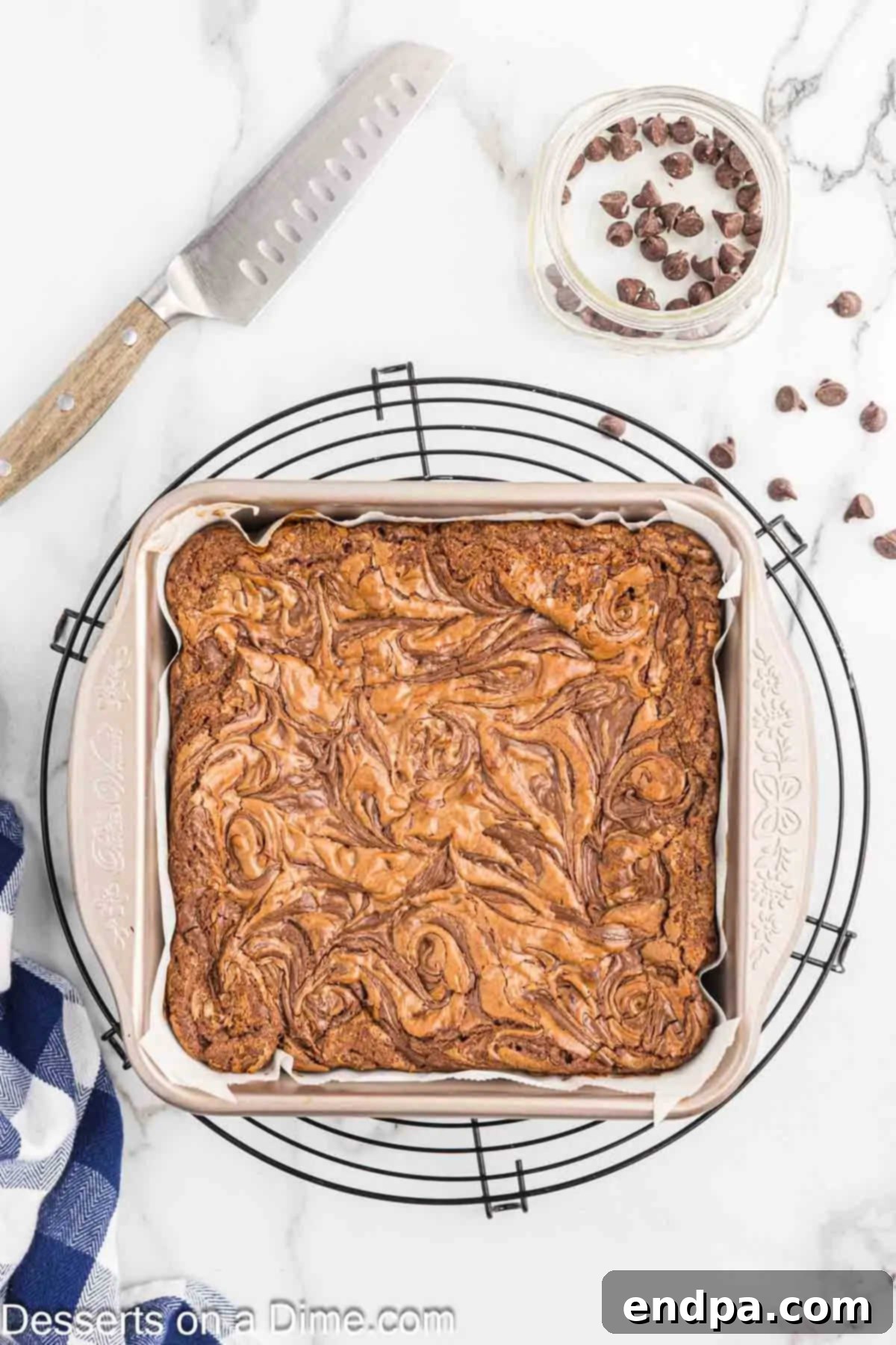 Freshly baked Nutella brownies cooling on a wire rack after being removed from the oven.