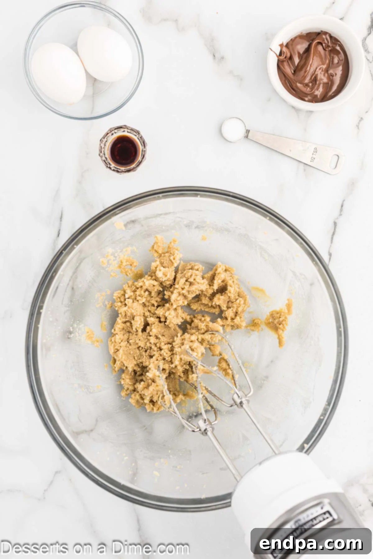 A mixing bowl filled with creamy butter and brown sugar, perfectly combined and fluffy.