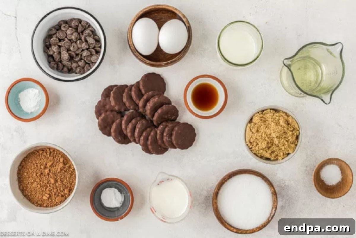 A collection of ingredients for Thin Mint cupcakes, including chocolate chips, butter, and cocoa powder, laid out on a wooden surface.