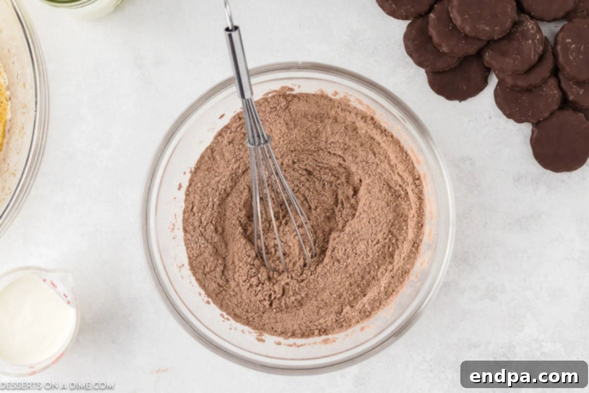 The wet ingredients for the Thin Mint cupcake batter are well combined in a mixing bowl.