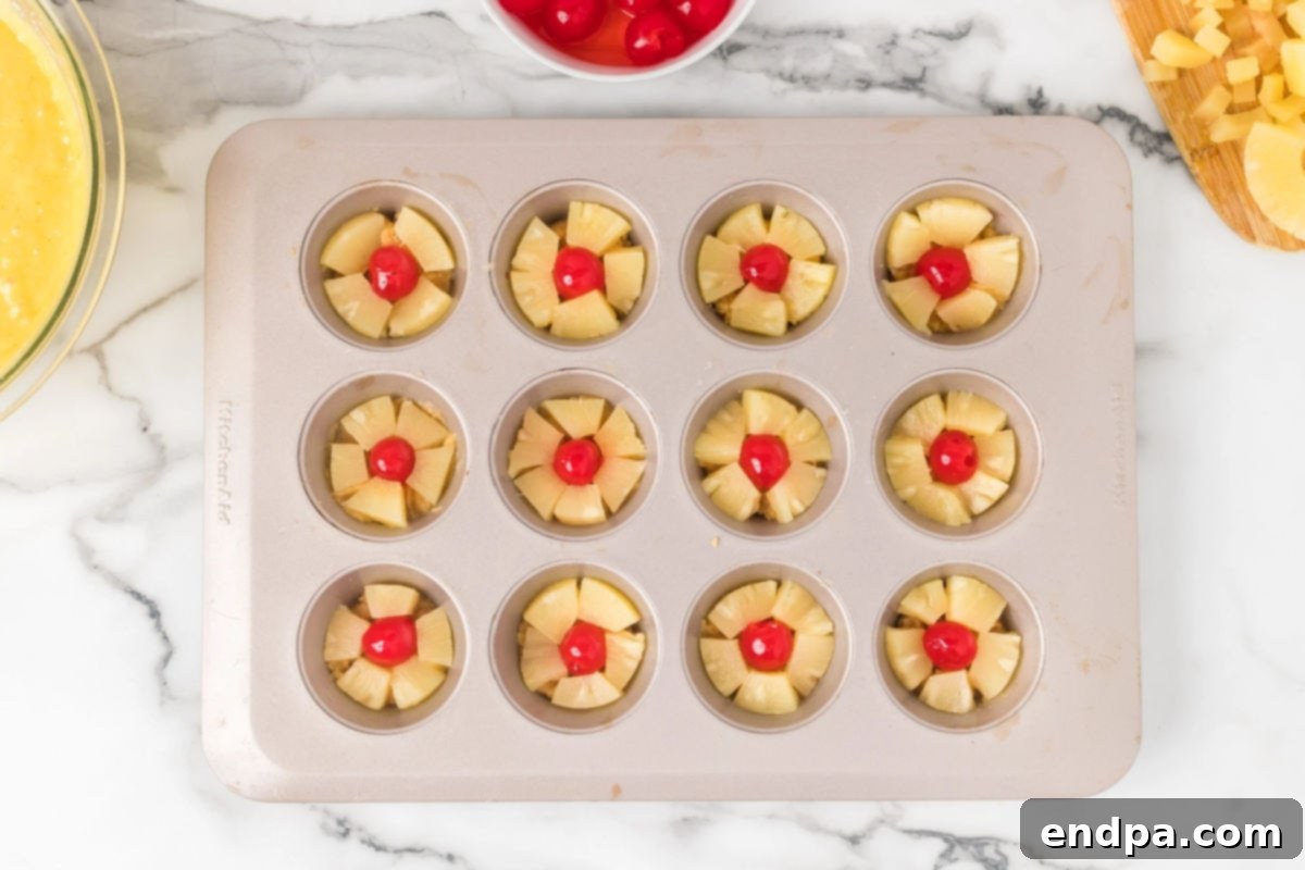 Pineapple slices on top of each muffin tin.