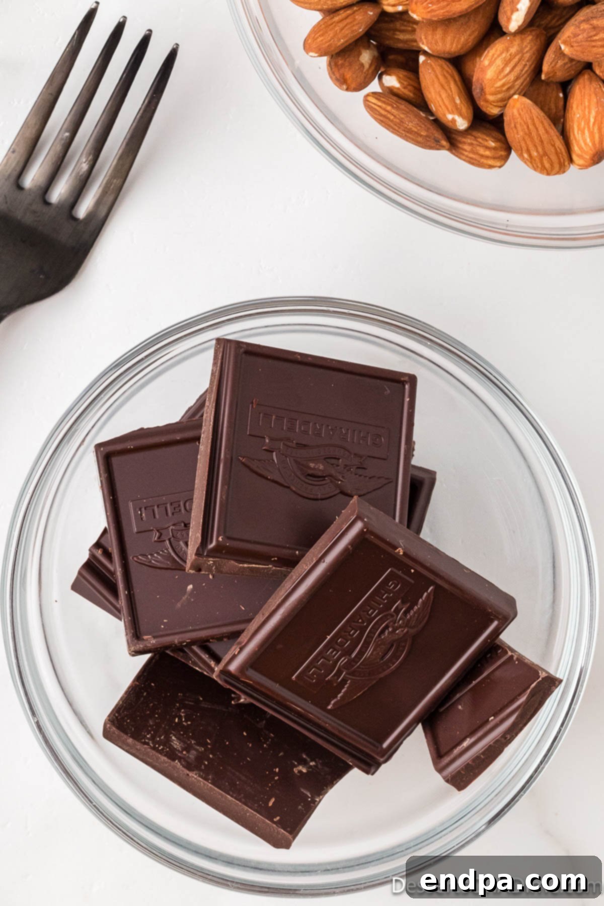 Decadent Dark Chocolate Almonds 3 High-quality dark chocolate pieces in a microwave-safe bowl, ready for melting.
