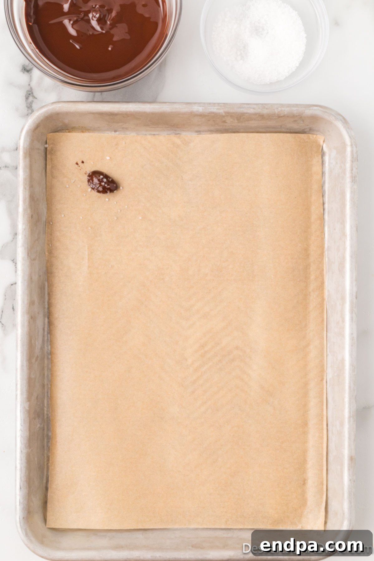 Decadent Dark Chocolate Almonds 7 Chocolate-covered almonds neatly arranged on a parchment-lined baking sheet, ready for the final touch.