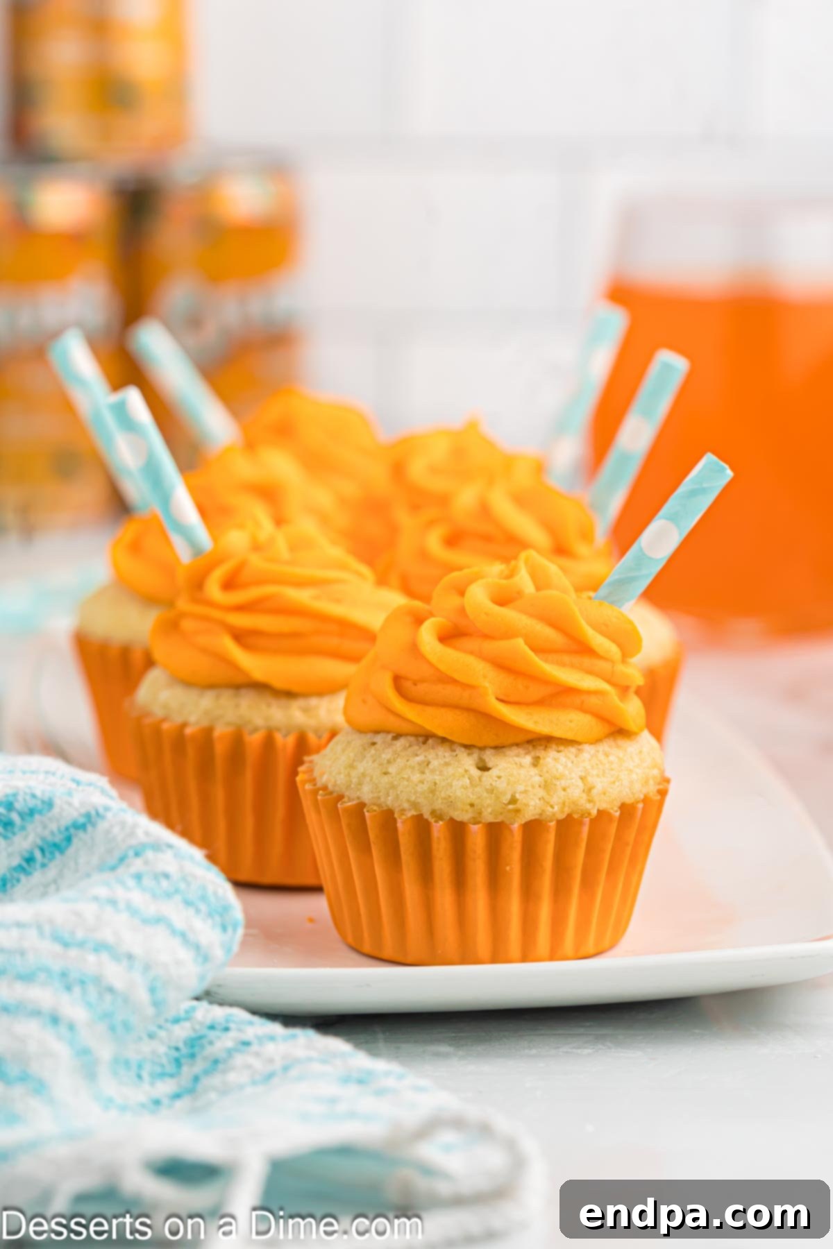 Orange Soda cupcakes on a plate.