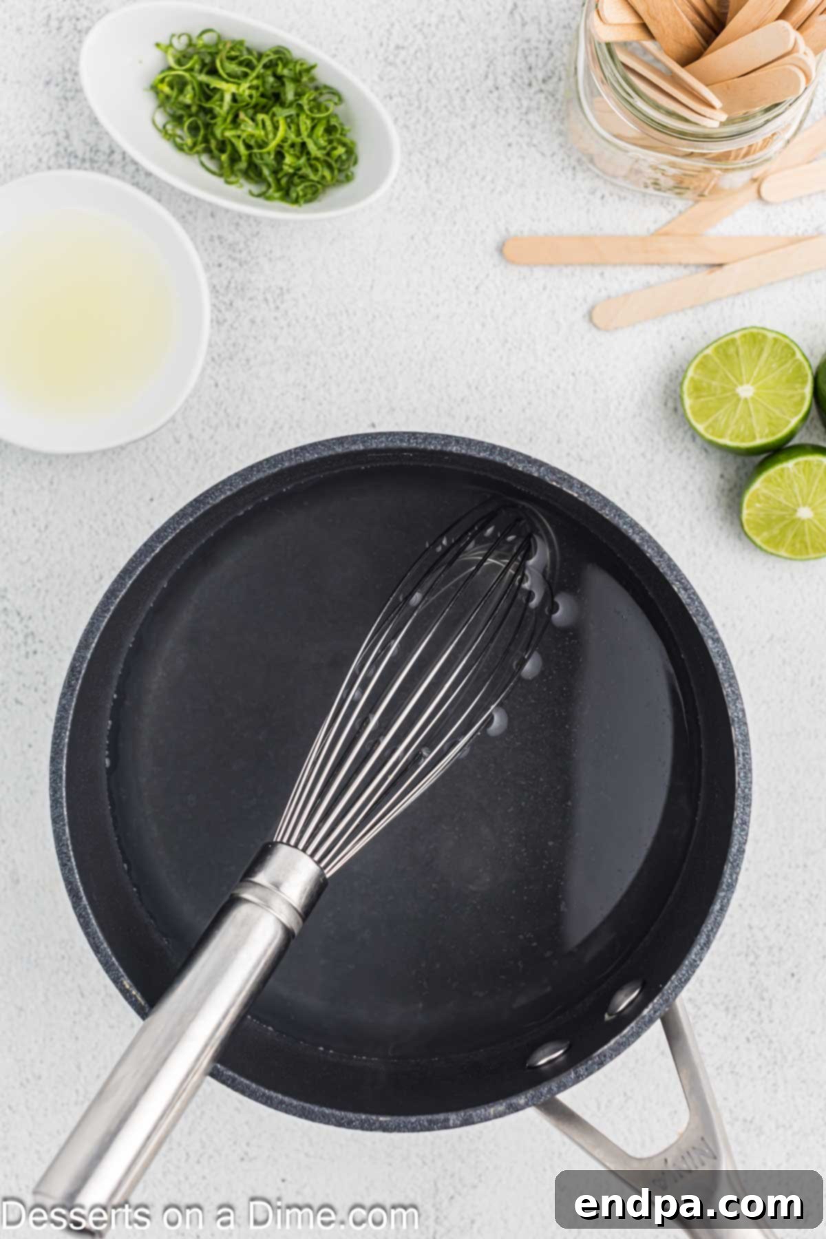 Water and sugar being simmered in a small pan to create simple syrup.