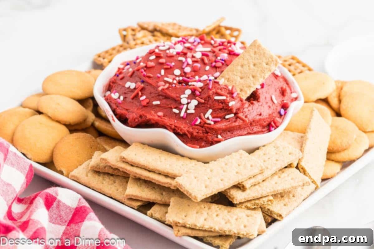 Red Velvet Delight Dip 2 Red Velvet Dip served in a bowl with an array of dippers arranged on a platter, inviting guests to savor the creamy dessert.