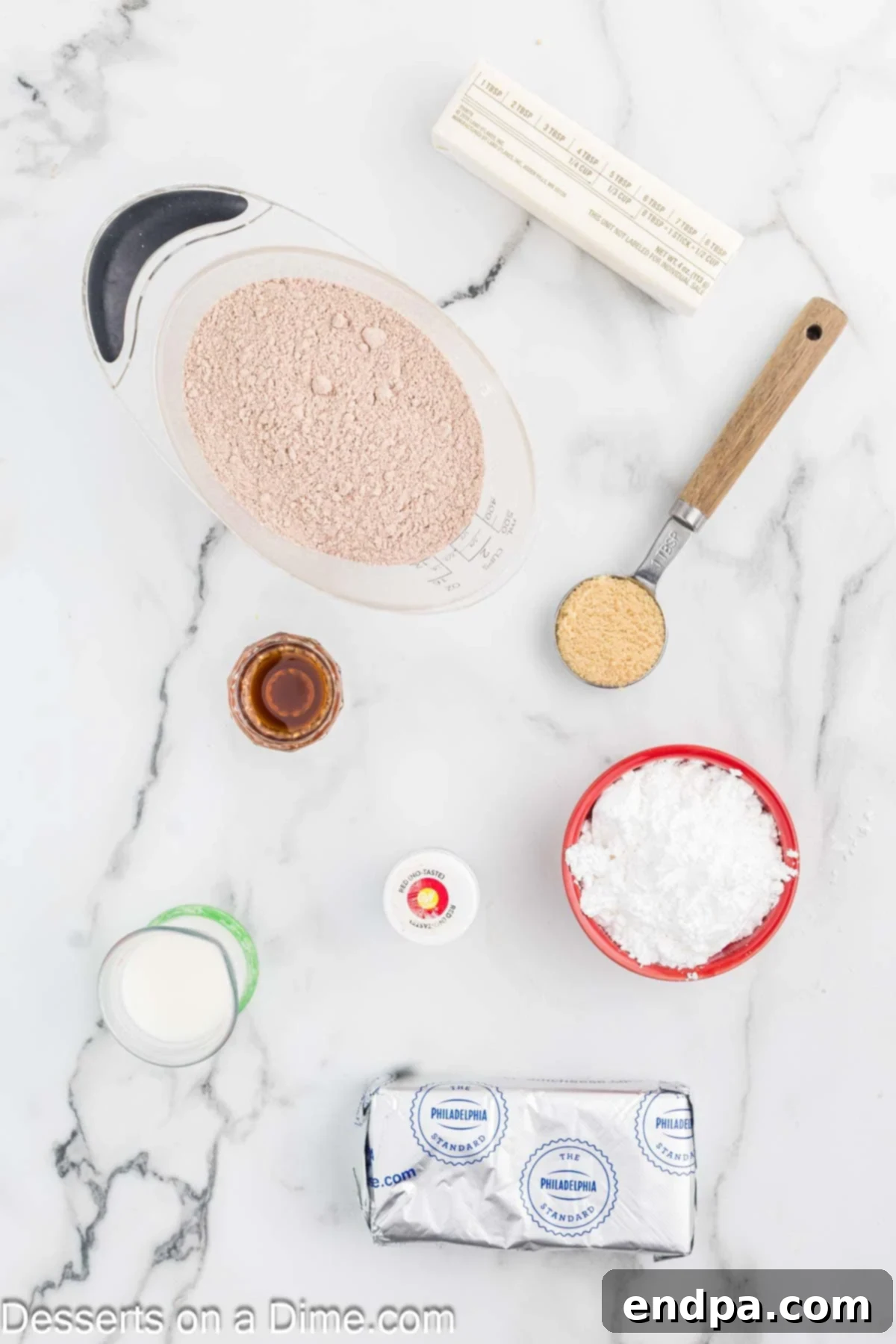 Red Velvet Delight Dip 3 A vibrant display of Red Velvet Dip ingredients: cream cheese, butter, red velvet cake mix, powdered sugar, brown sugar, vanilla, red food coloring, milk, sprinkles, and a variety of enticing dippers.