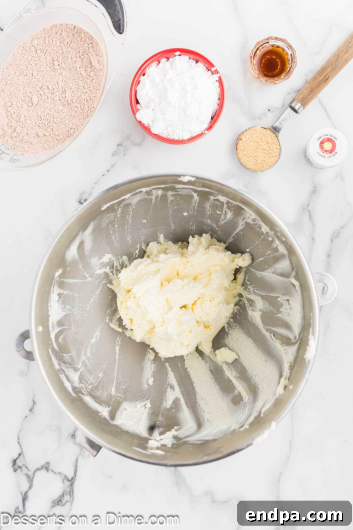 Red Velvet Delight Dip 5 Softened cream cheese in a mixing bowl, ready to be creamed with butter for the base of the Red Velvet Dip.