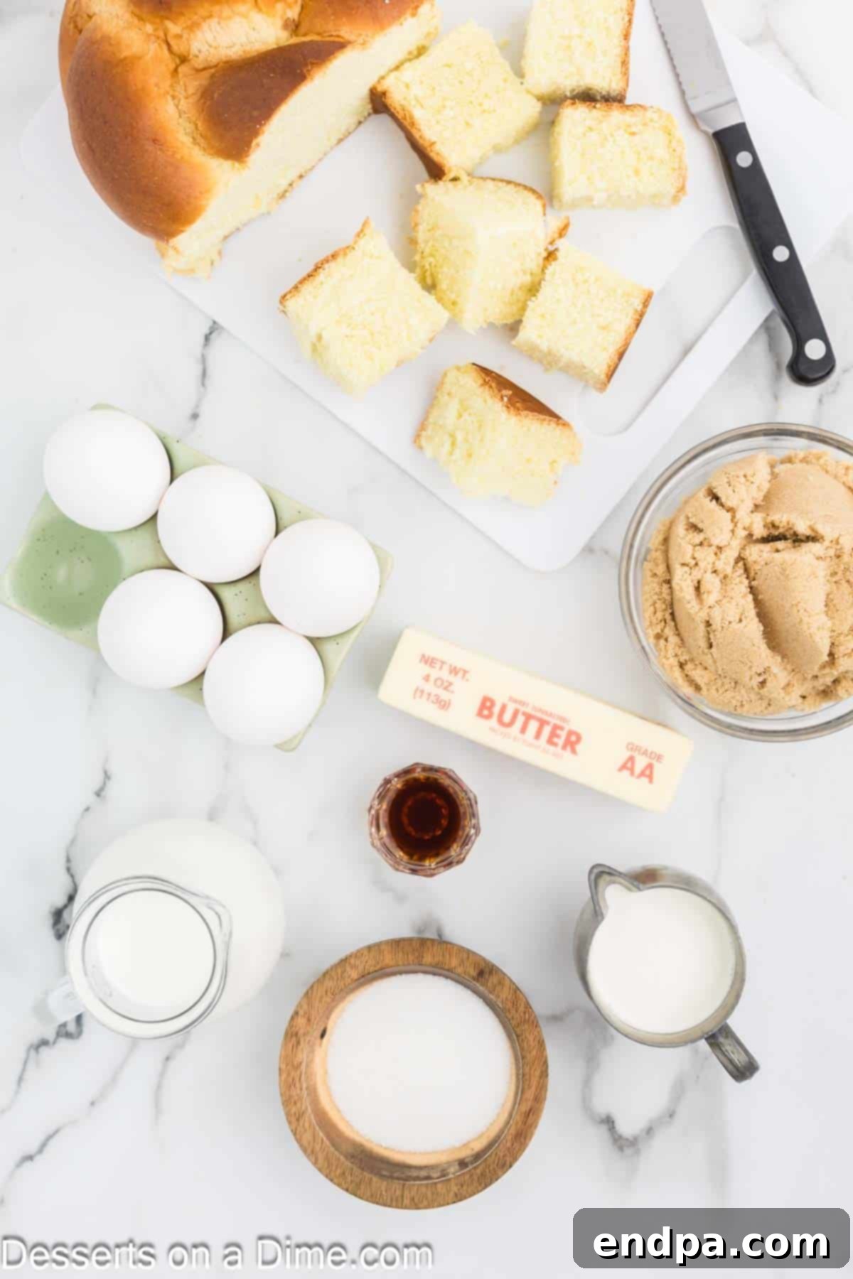 Ingredients for caramel bread pudding: challah bread, half and half, large eggs, vanilla extract, unsalted butter, brown sugar, granulated sugar, heavy cream.