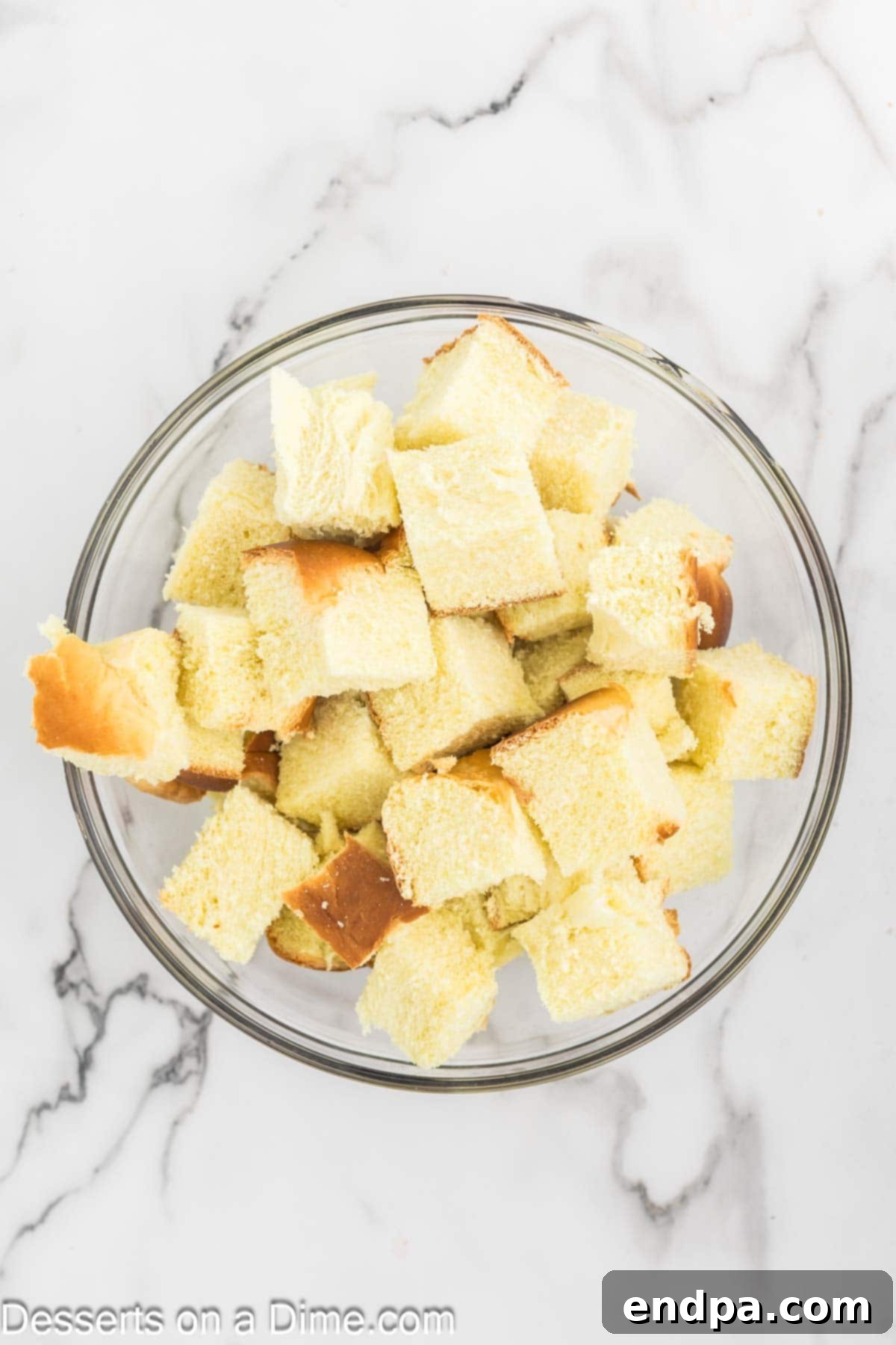 Mixing bowl of cut up bread.