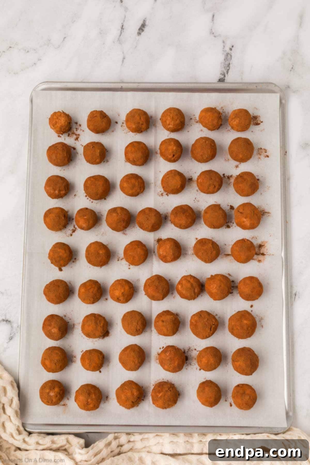 Irish Potato Balls on baking sheet coated in cinnamon
