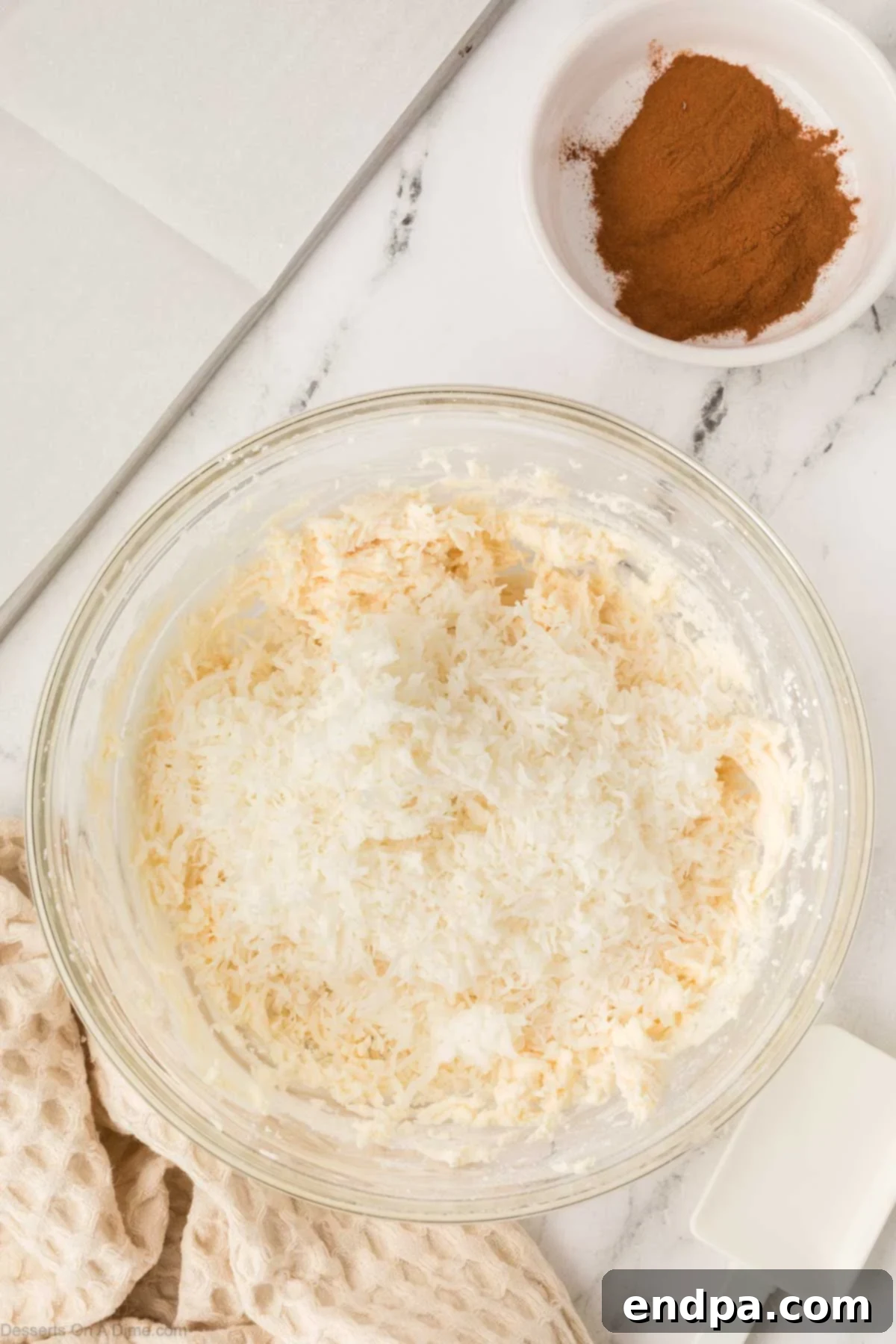 Shredded coconut added into bowl