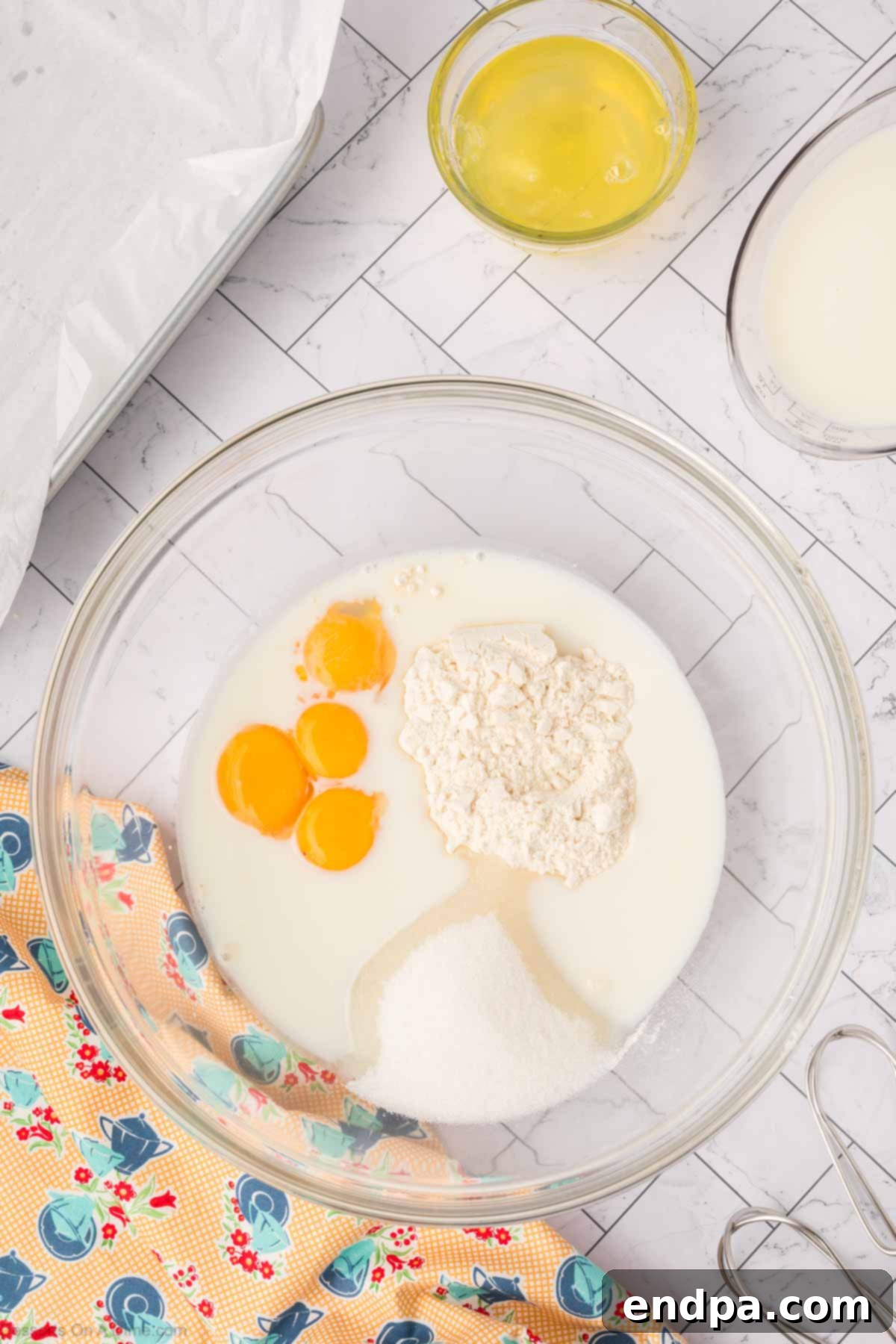Enchanted Dessert 5 Mixing bowl with eggs, flour, sugar and milk.