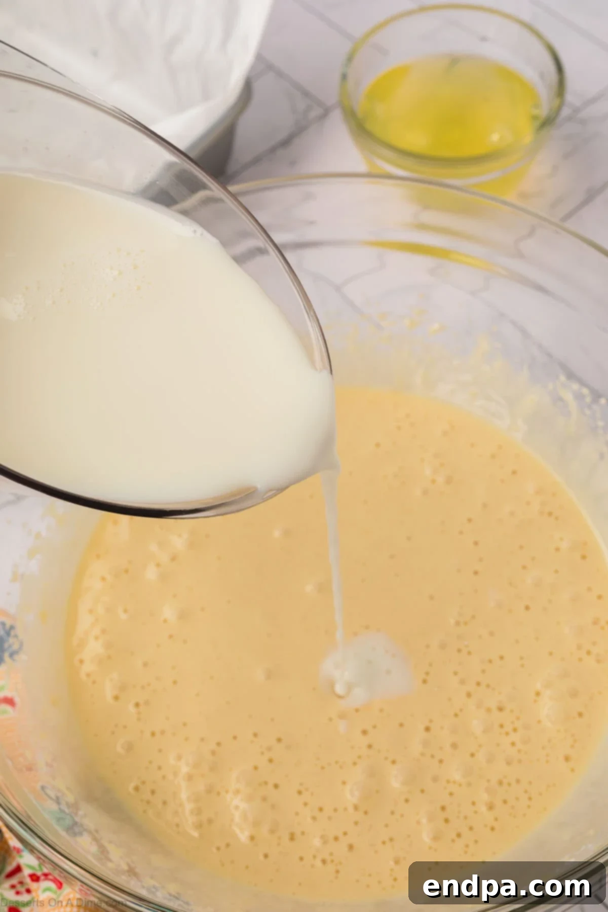 Enchanted Dessert 6 Milk poured into batter.