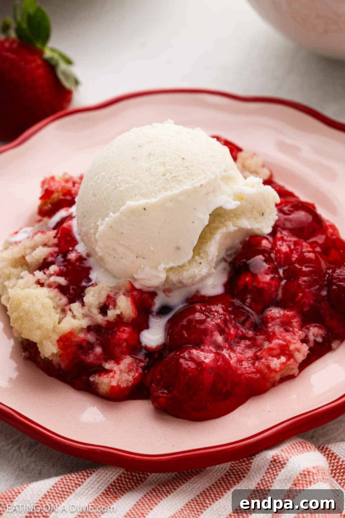 Crock Pot Strawberry Dump Cake topped with ice cream