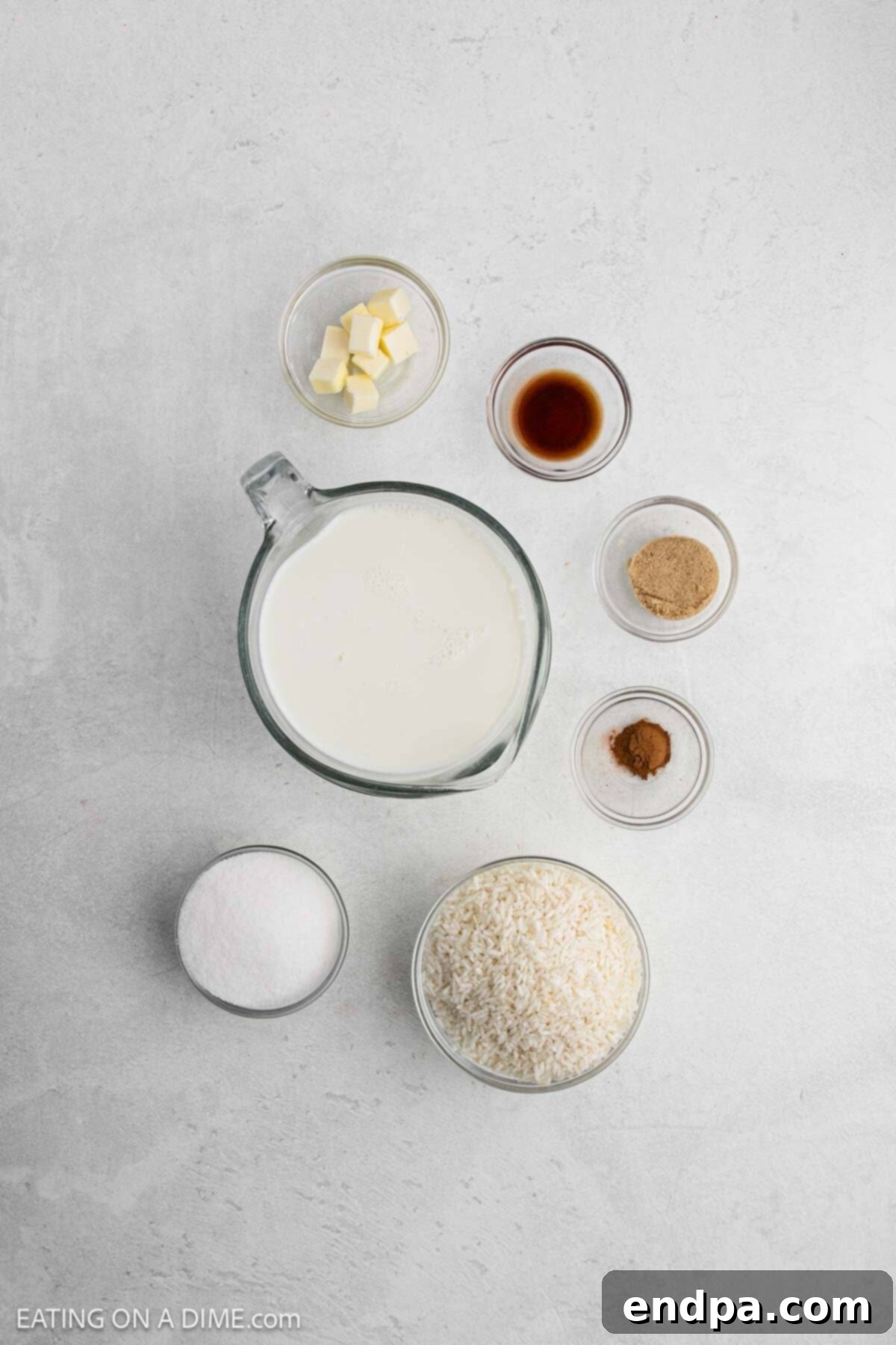 Ingredients for crock pot rice pudding - milk, sugar, brown sugar, instant rice, cinnamon, vanilla, butter.