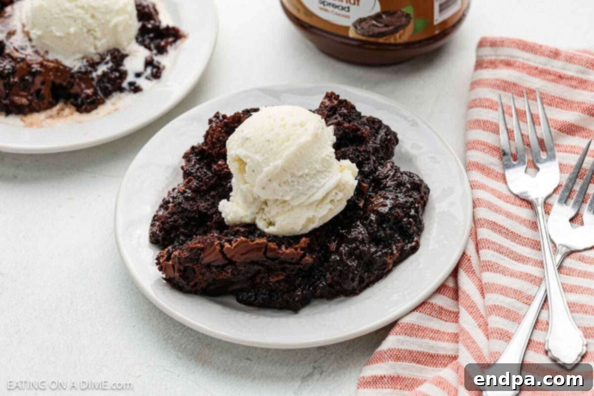 Crock Pot Chocolate Dump Cake topped with ice cream in bowls