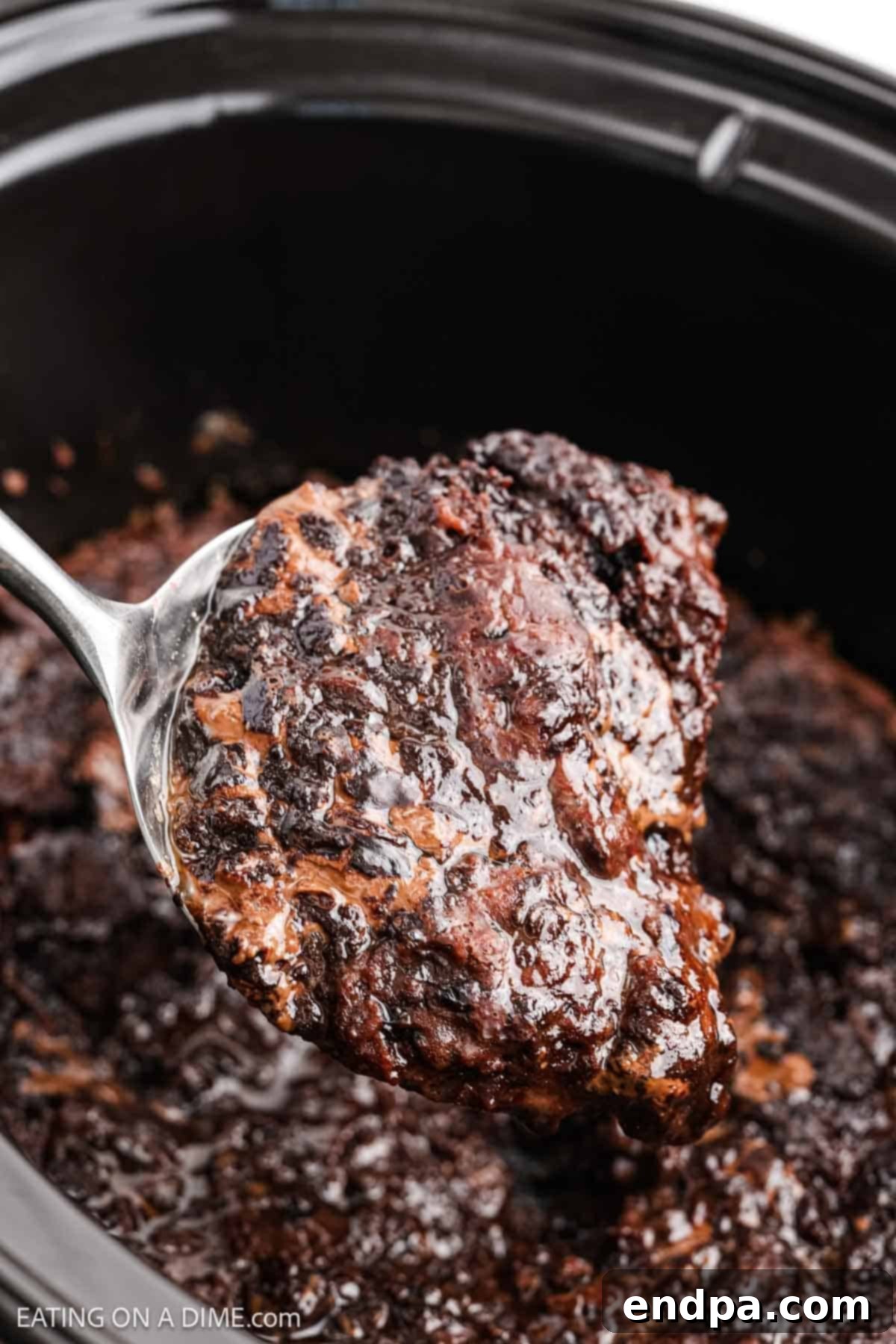 Spoon in slow cooker scooping dessert