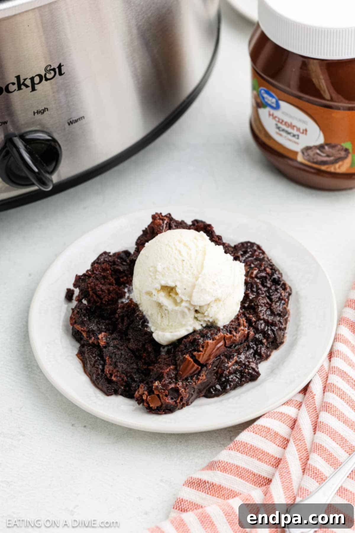 Serving of cake with ice cream on a white plate
