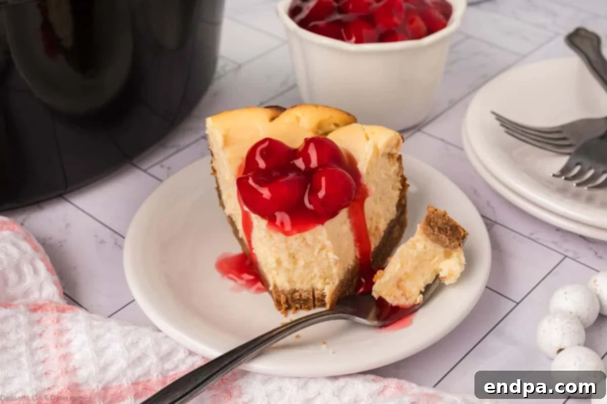 Slow Cooker Cheesecake 2 Slice of Crockpot Cheesecake with cherry topping
