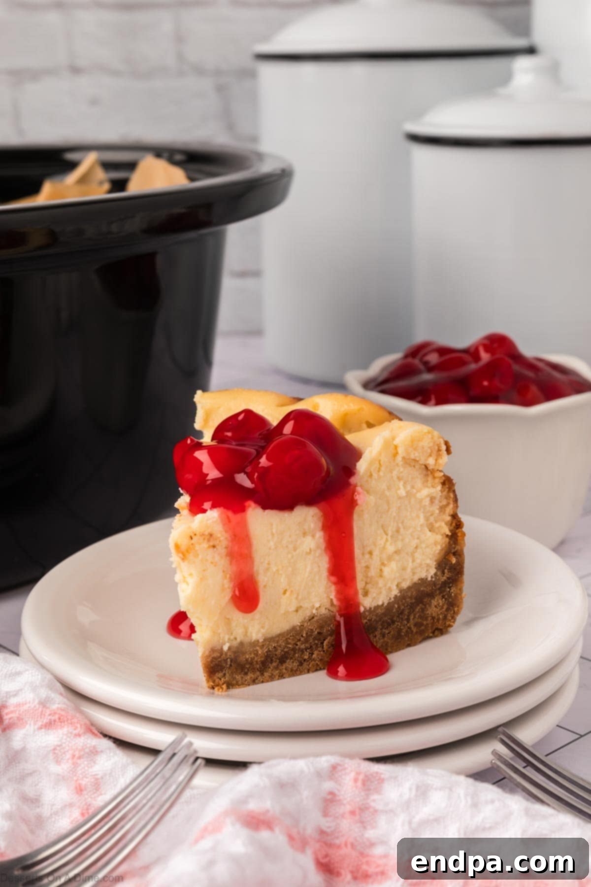Slow Cooker Cheesecake 12 Slice of Crockpot Cheesecake with cherry topping