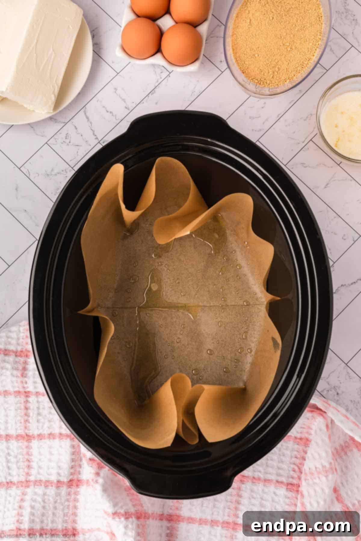 Slow Cooker Cheesecake 4 Crock pot lined with parchment paper
