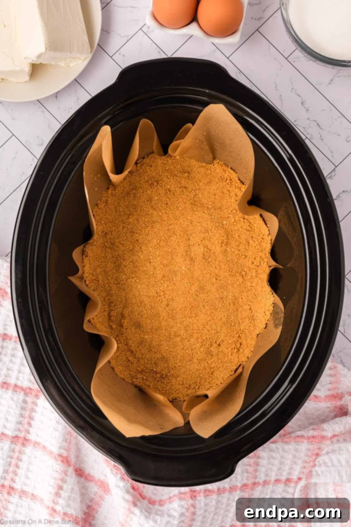 Slow Cooker Cheesecake 6 Graham cracker crust pressed into crock pot