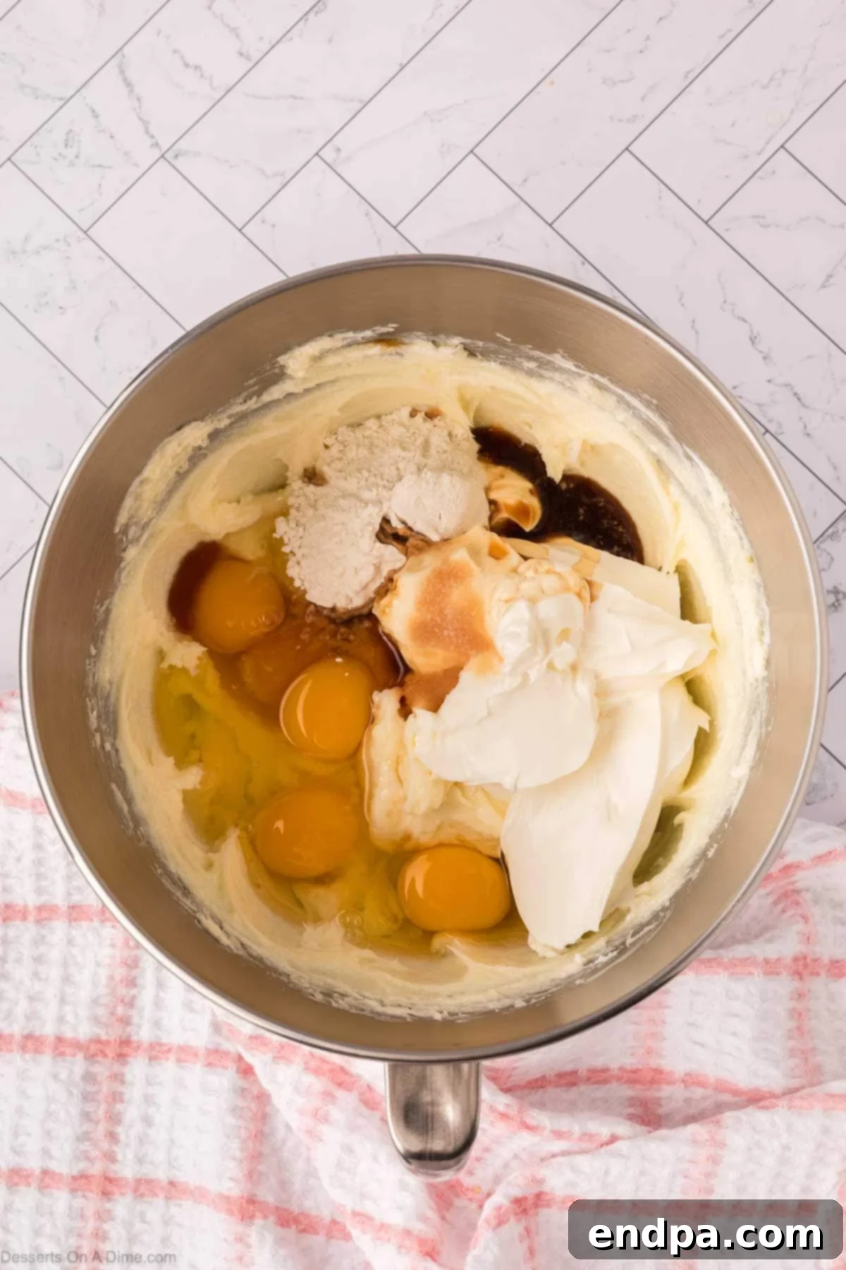 Slow Cooker Cheesecake 8 Eggs, sour cream and vanilla added to mixing bowl