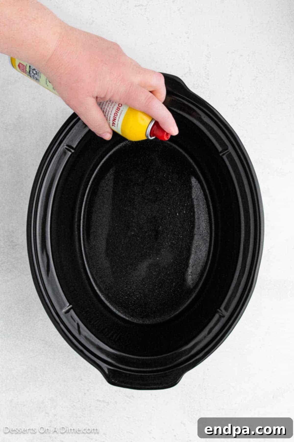 Slow Cooker Chocolate Fudge Brownies 4 Crock pot being sprayed with cooking spray