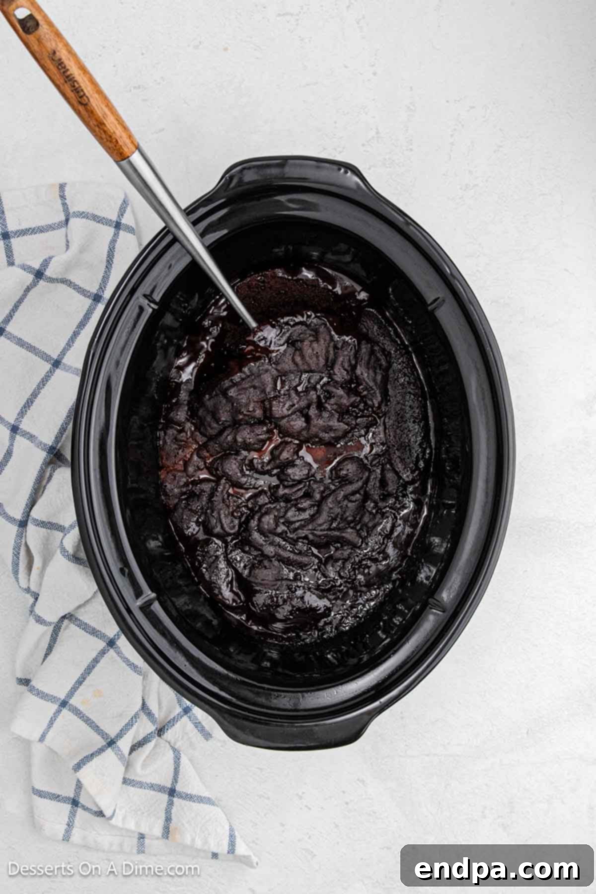 Slow Cooker Chocolate Fudge Brownies 9 Dessert ready to serve with a spoon in the slow cooker