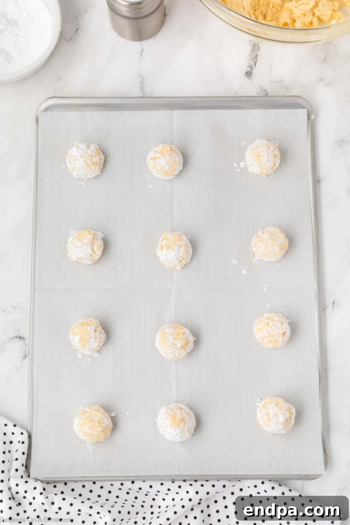 Cake Mix Butter Cookies: Ooey Gooey Goodness 9 Cookie dough balls on baking sheet.