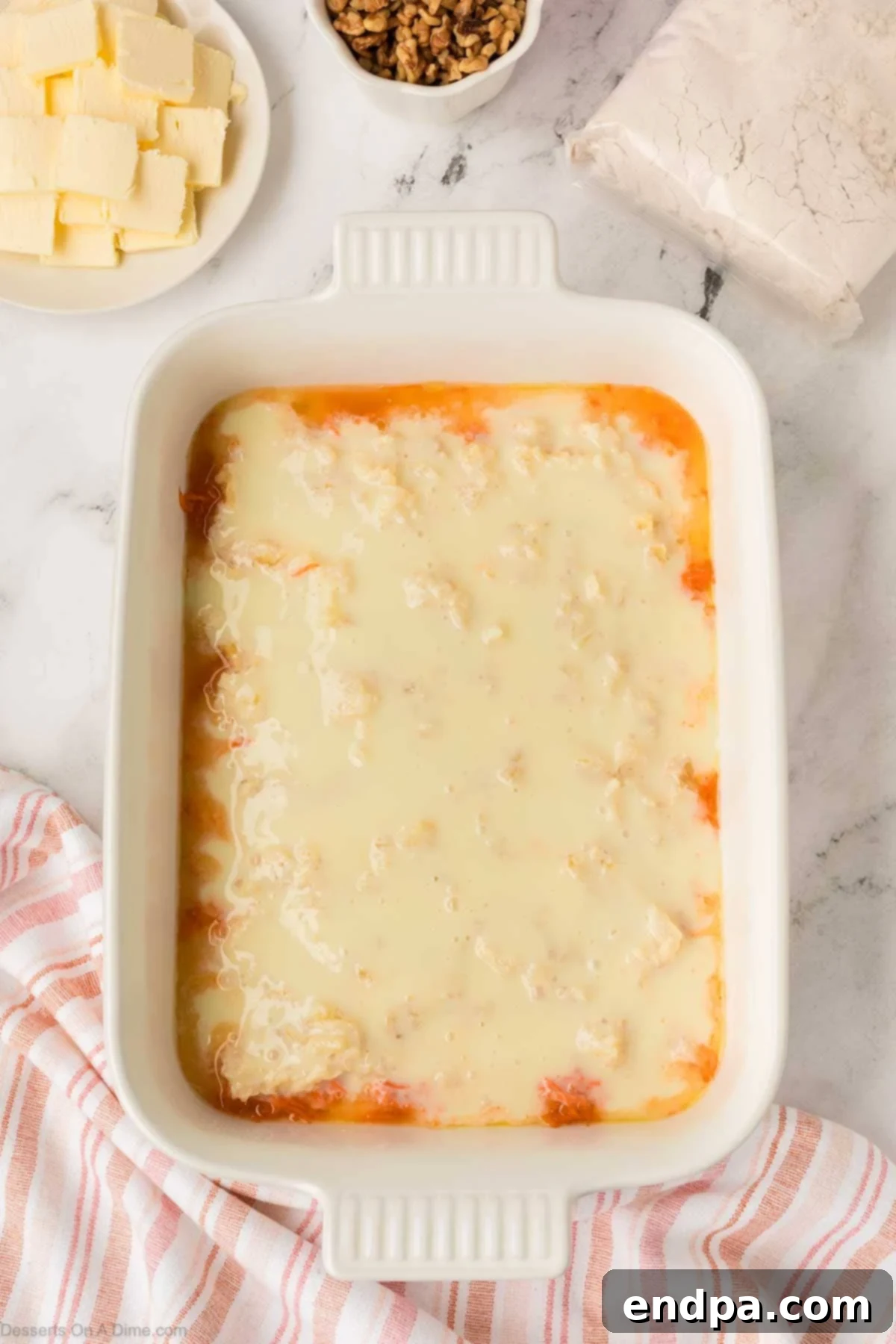 Sweetened condensed milk evenly poured on top of the pineapple.
