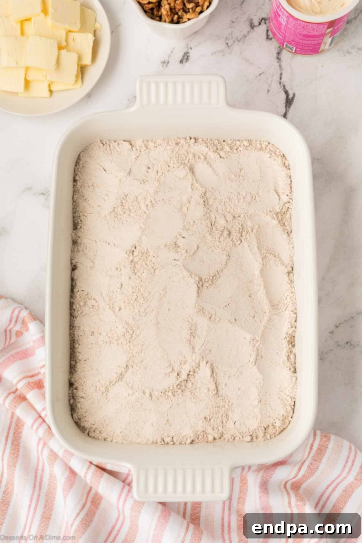 Dry cake mix spread evenly on top of the wet ingredients.