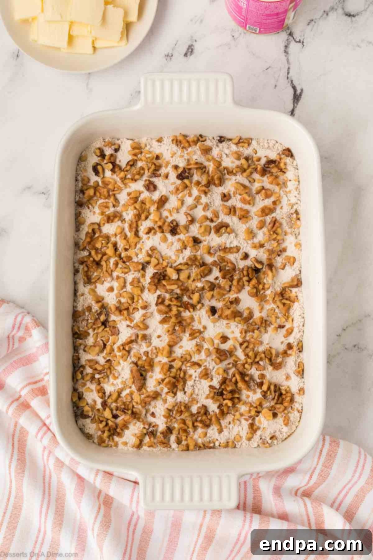 Chopped nuts sprinkled on top of the cake mix.